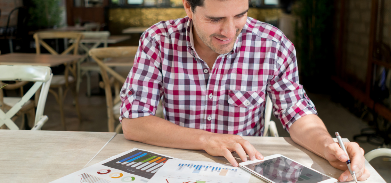 Restaurant owner working on accounting in dining room.