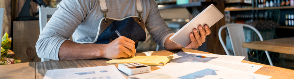Restaurant operator writing on notepad